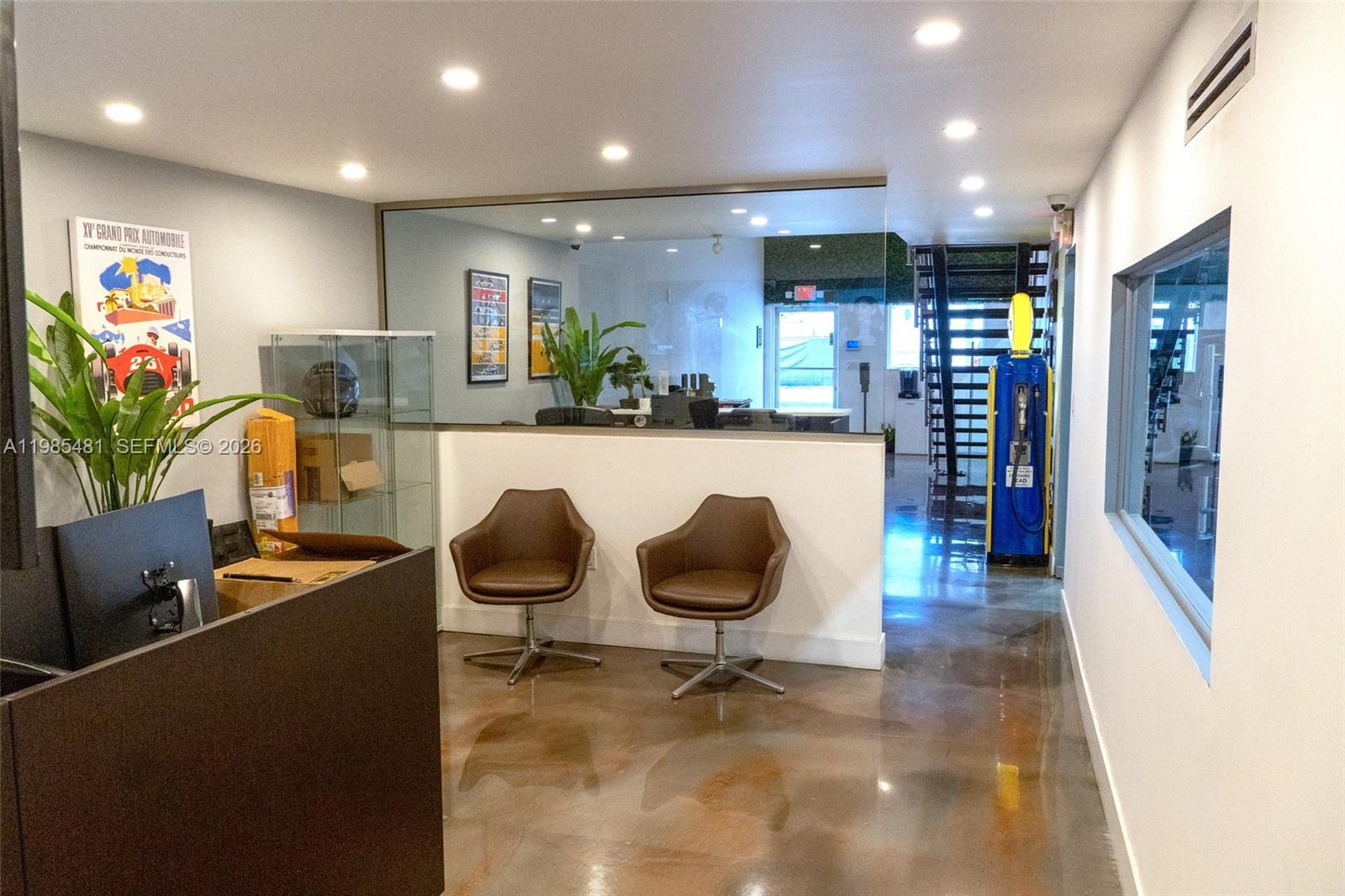 A reception area features two brown chairs, a glass partition, and a decorative gas pump — 5836 Rodman St, Hollywood FL 33023, HOLLYWOOD, FL