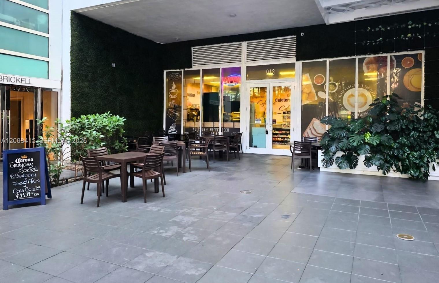 A cafe storefront features outdoor seating with tables and chairs on a tiled patio — XXXX BRICKELL AVE, Miami FL 33131, MIAMI, FL