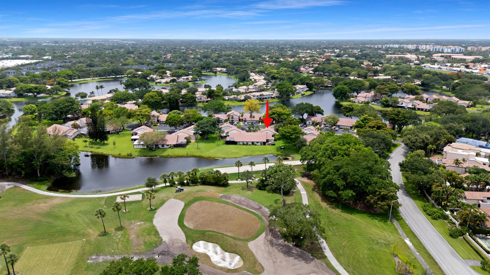 An aerial view shows a residential complex surrounded by lakes and a golf course — 3018 Lakeshore Drive, Deerfield Beach FL 33442, DEERFIELD BEACH, FL