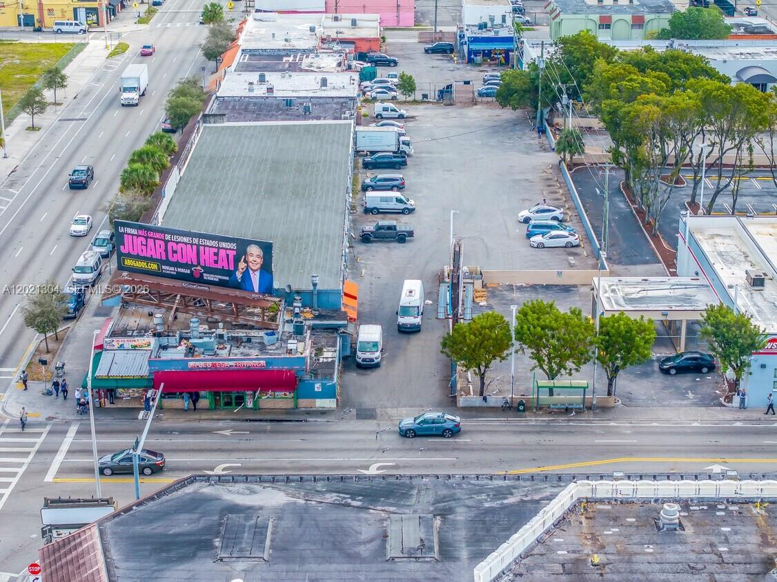 An aerial view shows a commercial building with a large billboard and an adjacent parking lot — 1190 W Flagler St, Miami FL 33130, MIAMI, FL