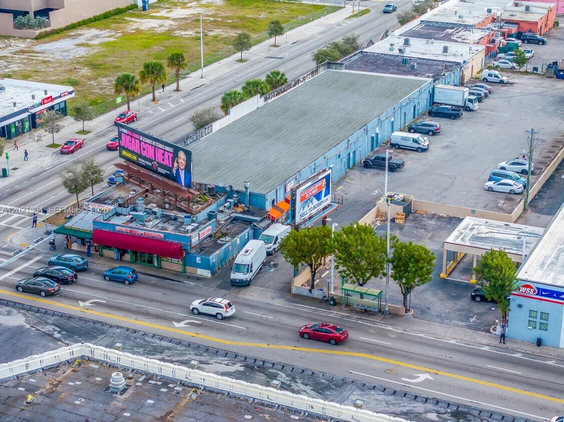 An aerial view shows a commercial building with a large billboard and an adjacent parking lot — 1190 W Flagler St, Miami FL 33130, MIAMI, FL