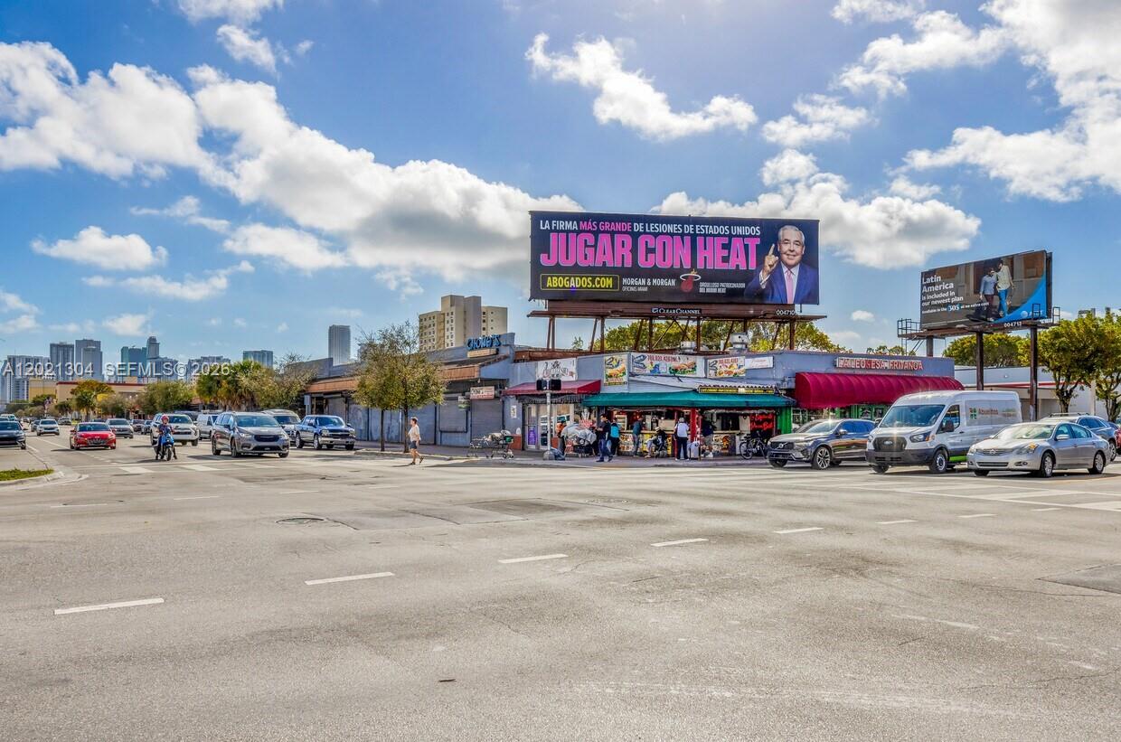A street-level view shows a commercial building with a large billboard above a restaurant — 1190 W Flagler St, Miami FL 33130, MIAMI, FL