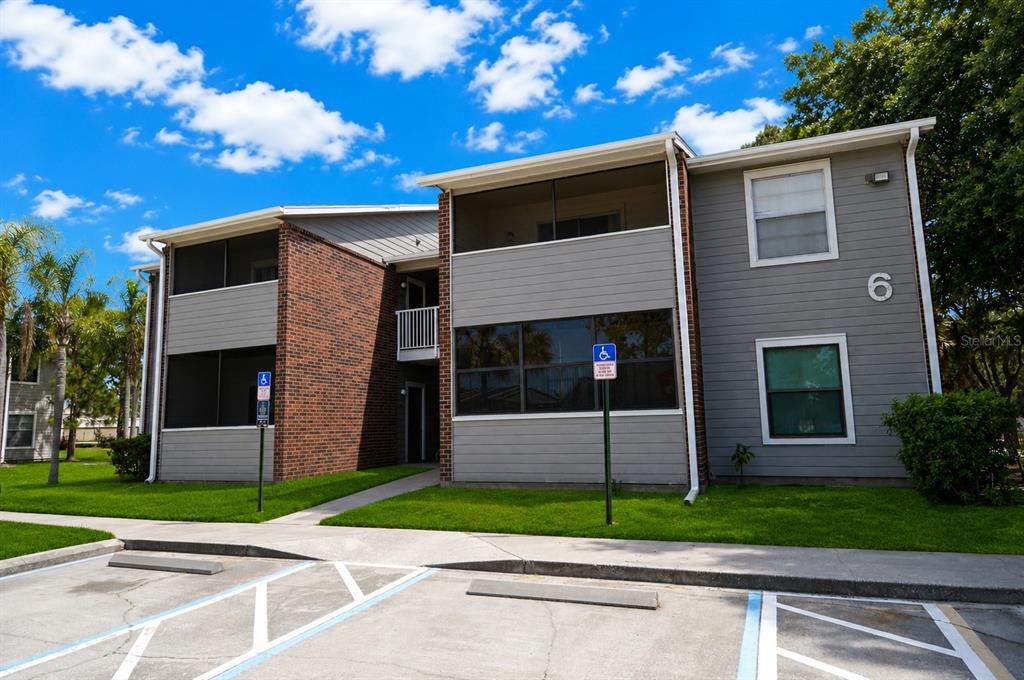 A two-story apartment building with a brick and gray siding exterior and parking spaces — 1400 GANDY BOULEVARD N UNIT 607, ST PETERSBURG, FL