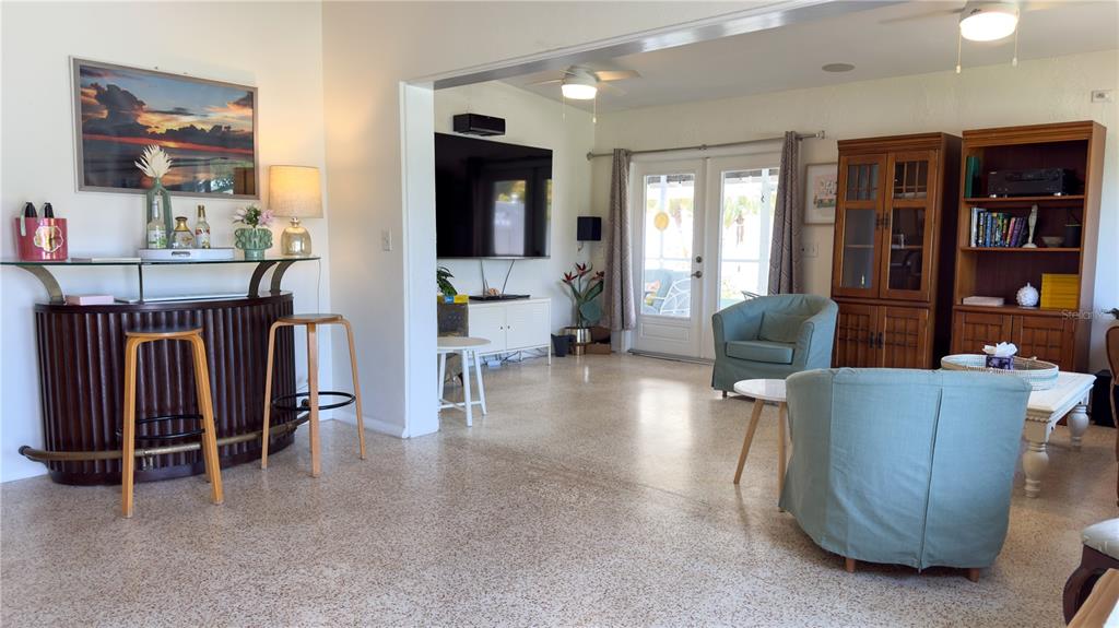 A living room features a bar area, a television, and two light blue armchairs — 2215 ALVARADO LANE, SARASOTA, FL