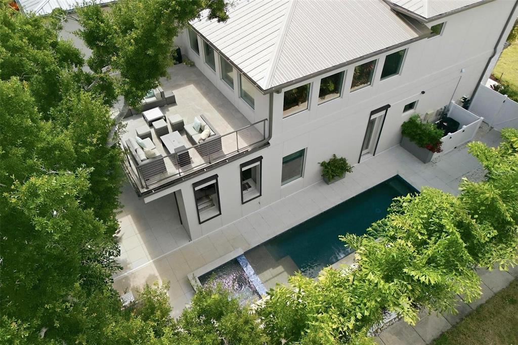 An aerial view of a modern house with a rooftop deck, swimming pool, and landscaping — 1805 GOLDENROD STREET, SARASOTA, FL