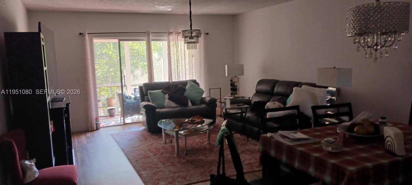 A living room features dark leather furniture, a glass coffee table, and a dining area — 6731 Cypress Rd # 310, Plantation FL 33317, PLANTATION, FL
