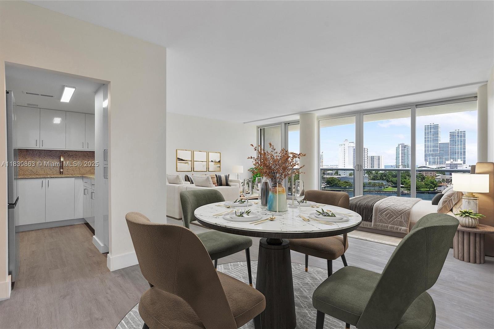 A dining area with a round marble table sits adjacent to a kitchen and living space — 900 Bay Dr, Miami Beach FL 33141, MIAMI BEACH, FL