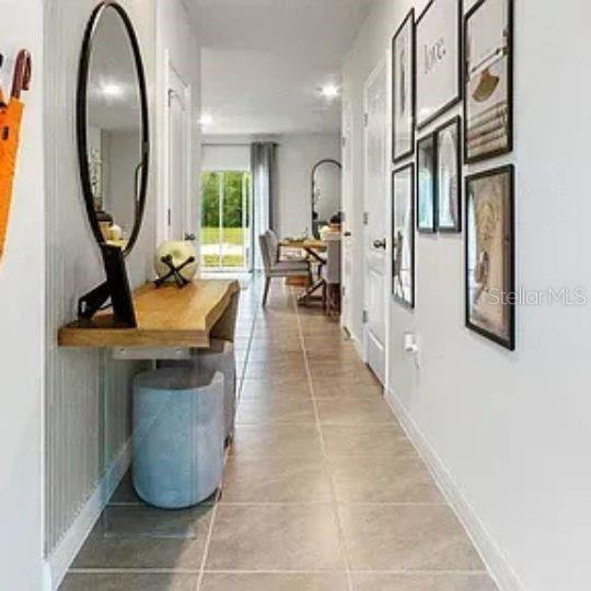 A hallway features a live-edge console table, a round mirror, and a gallery wall — 4615 LINDA DRIVE, LAKE WALES, FL