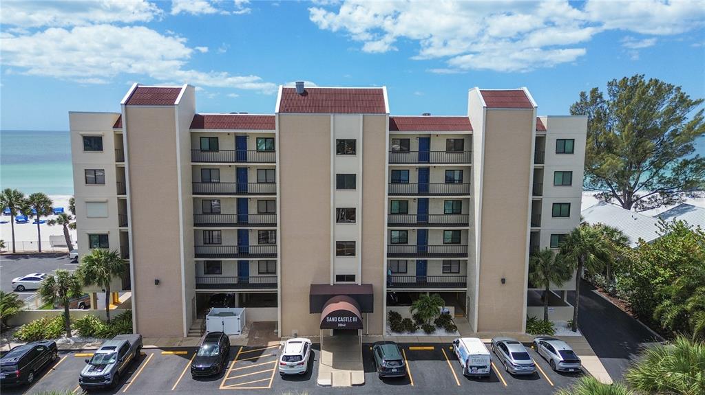 An aerial view of the Sand Castle III condominium building with a parking lot — 20040 GULF BOULEVARD UNIT 402, INDIAN ROCKS BEACH, FL