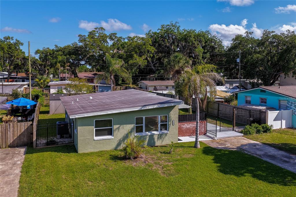 An aerial view of a light green single-story house with a flat roof and driveway — 723 STEELE AVENUE, SOUTH DAYTONA, FL