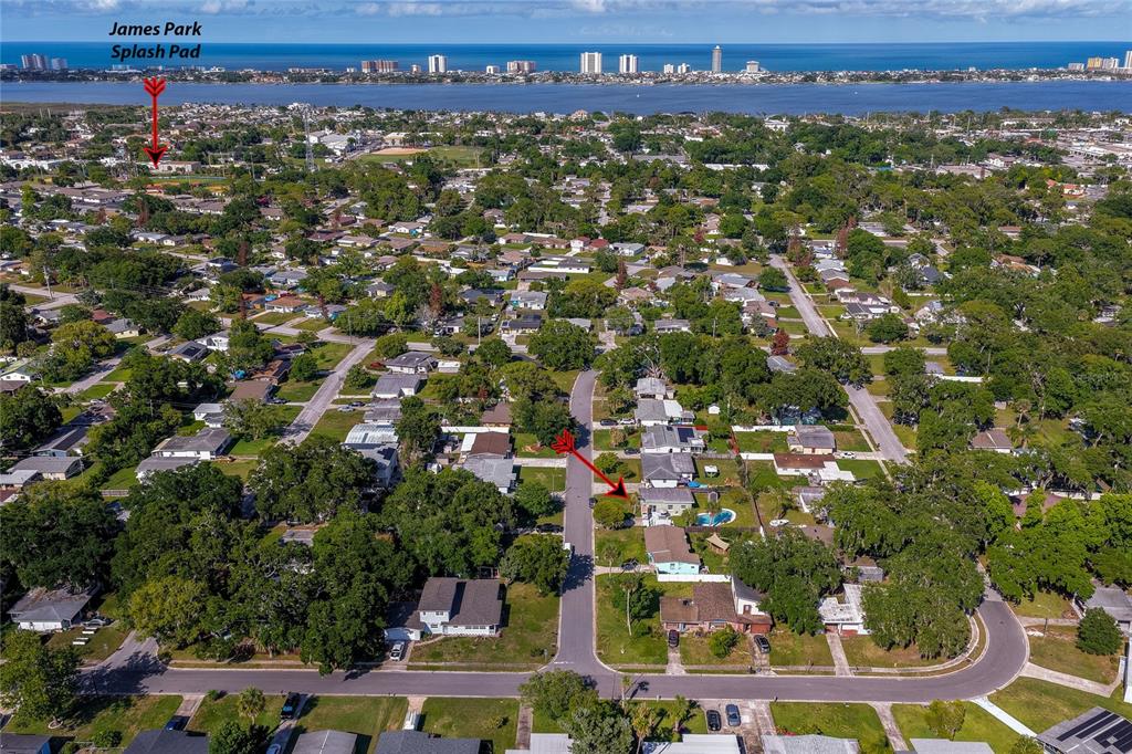 An aerial view shows a residential neighborhood with a red arrow pointing to a house — 723 STEELE AVENUE, SOUTH DAYTONA, FL