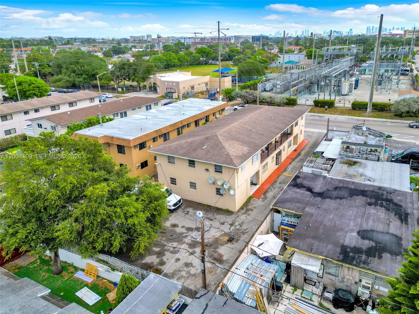 An aerial view shows two multi-story apartment buildings next to a power substation — 410 NW 47th Ave, Miami FL 33126, MIAMI, FL