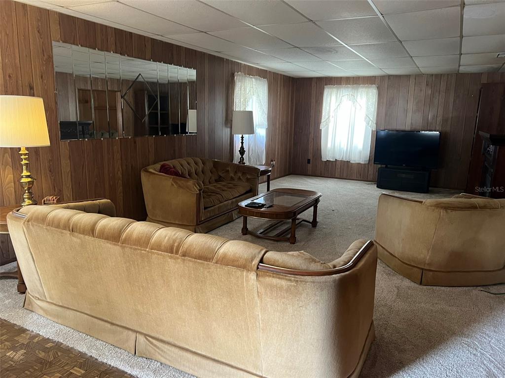 A living room features wood-paneled walls, a drop ceiling, and a matching velvet furniture set — 12482 161ST ROAD, LIVE OAK, FL