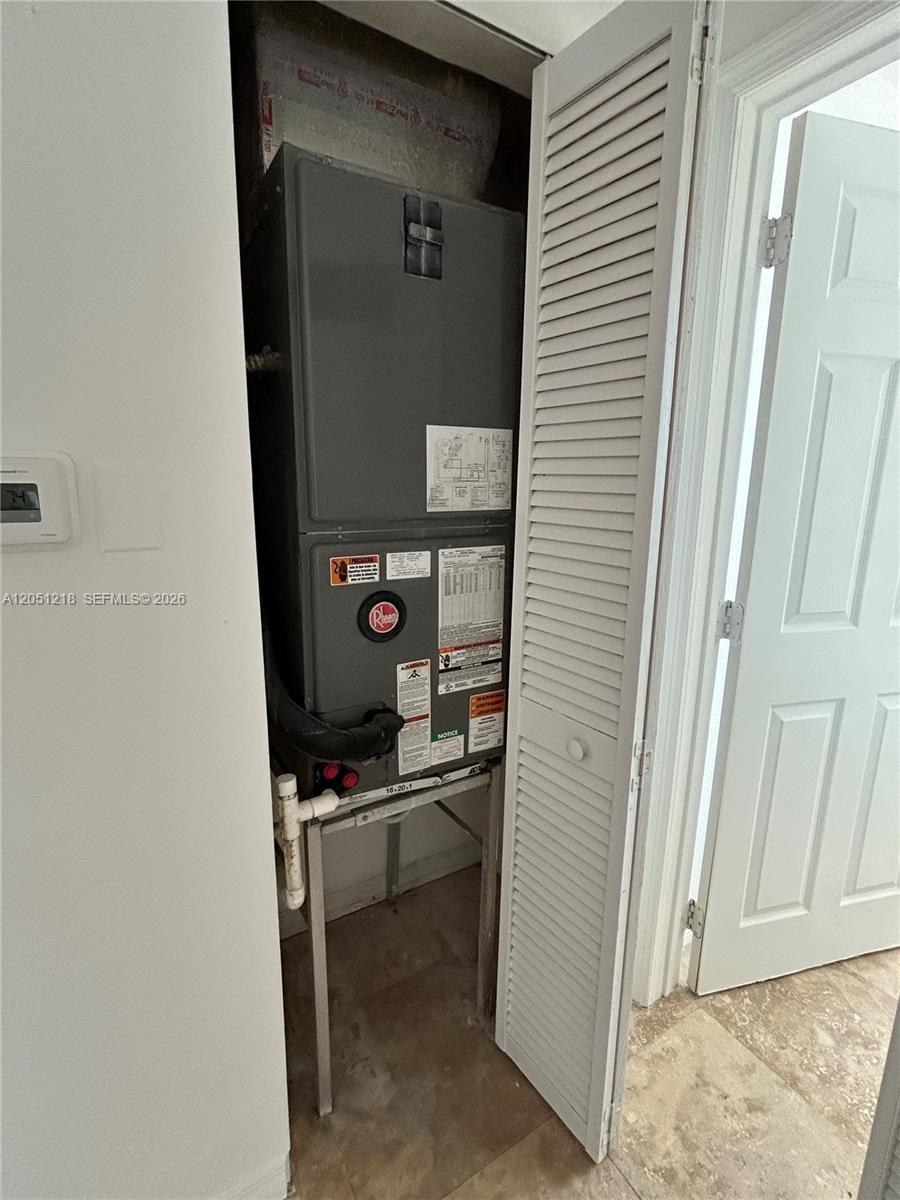 A Rheem HVAC air handler unit is installed inside a closet with louvered doors — 953 SW 10th St # 3, Miami FL 33130, MIAMI, FL