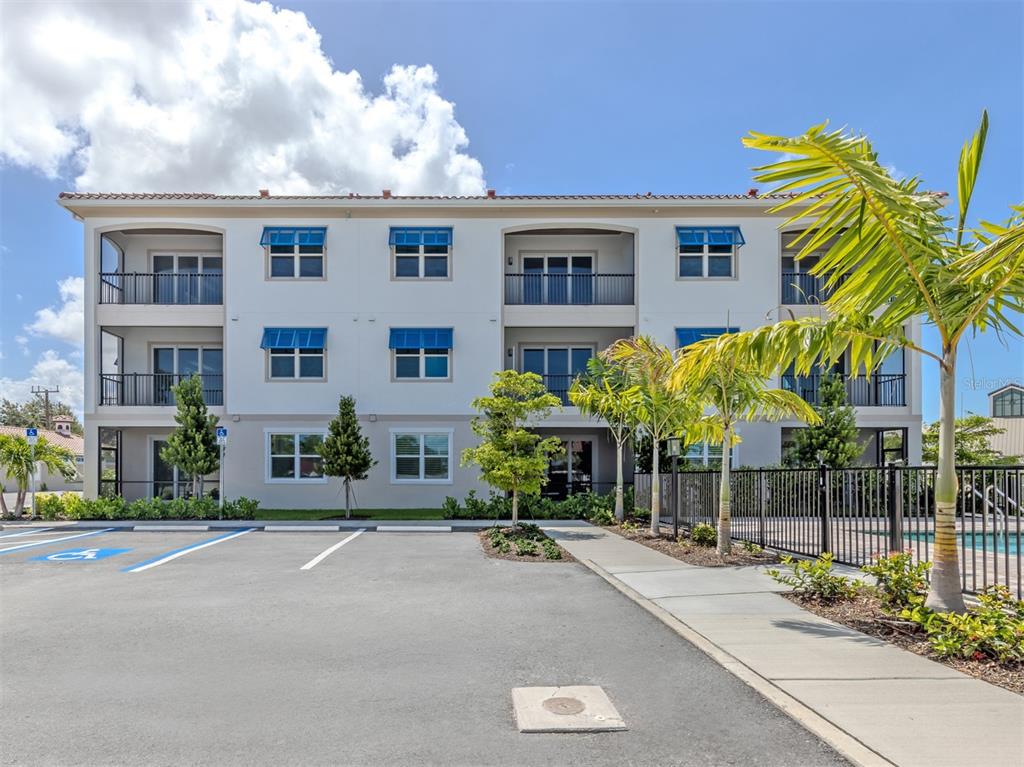 A row of garage units with beige doors and a terracotta tile roof — 787 S. TAMIAMI TRAIL UNIT 301, VENICE, FL