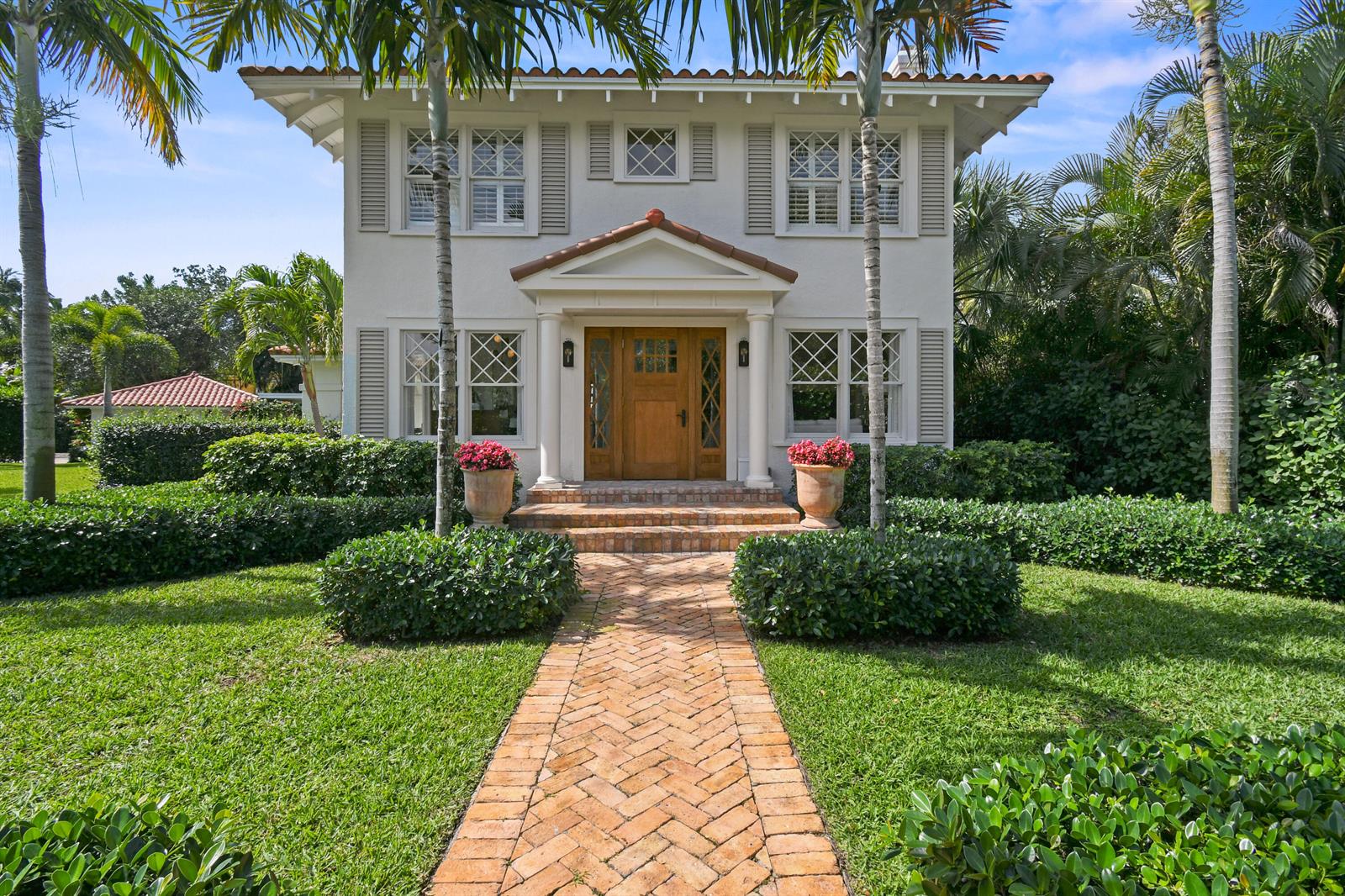 A two-story house with a brick walkway, palm trees, and a wooden front door — 300 Buckingham Road, West Palm Beach FL 33405, WEST PALM BEACH, FL