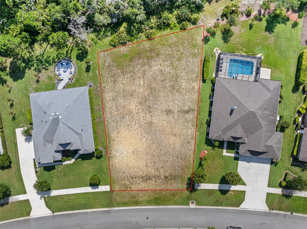 An aerial view shows a vacant residential lot outlined in red between two existing houses — 3040 ACOMA DRIVE, ORMOND BEACH, FL