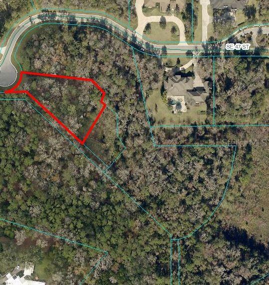 An aerial map shows a wooded residential lot outlined in red — 1400 SE 47TH STREET, OCALA, FL