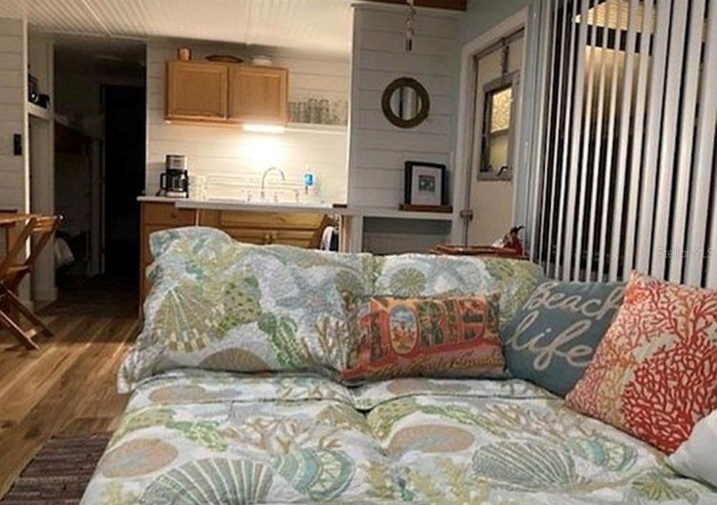 A view from a bed looking toward a kitchen with light wood cabinets and walls — 3721 116TH STREET W, BRADENTON, FL