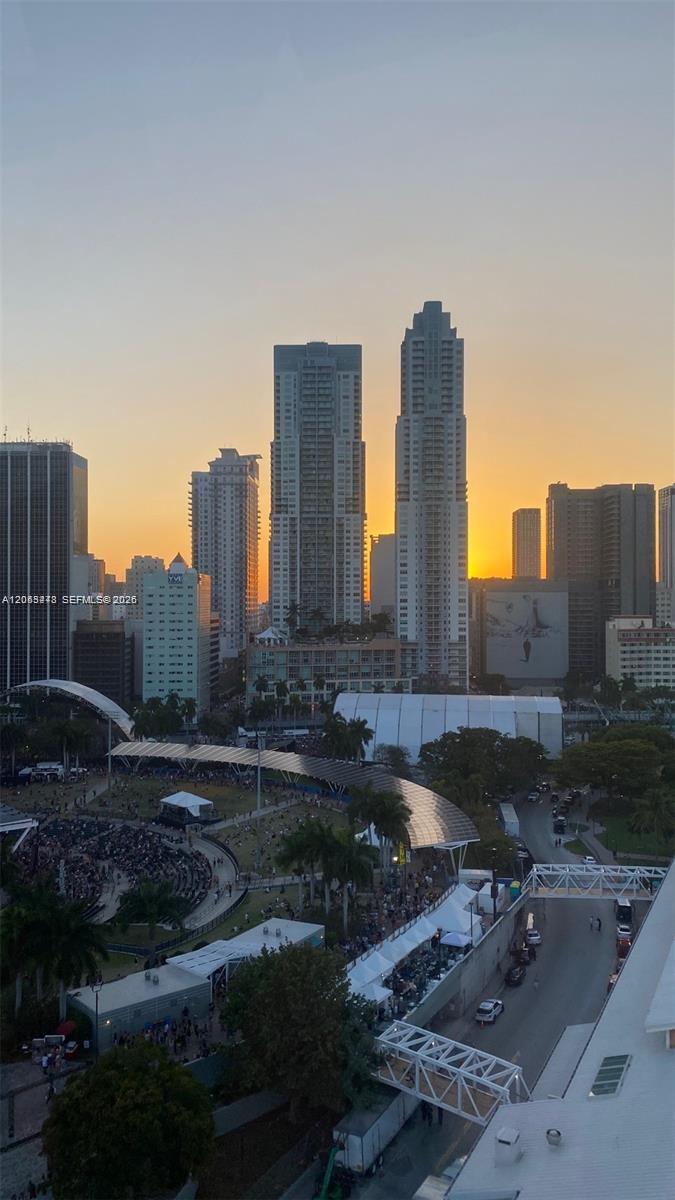 An elevated view of a city skyline at sunset overlooking a park and event space — MIAMI, FL
