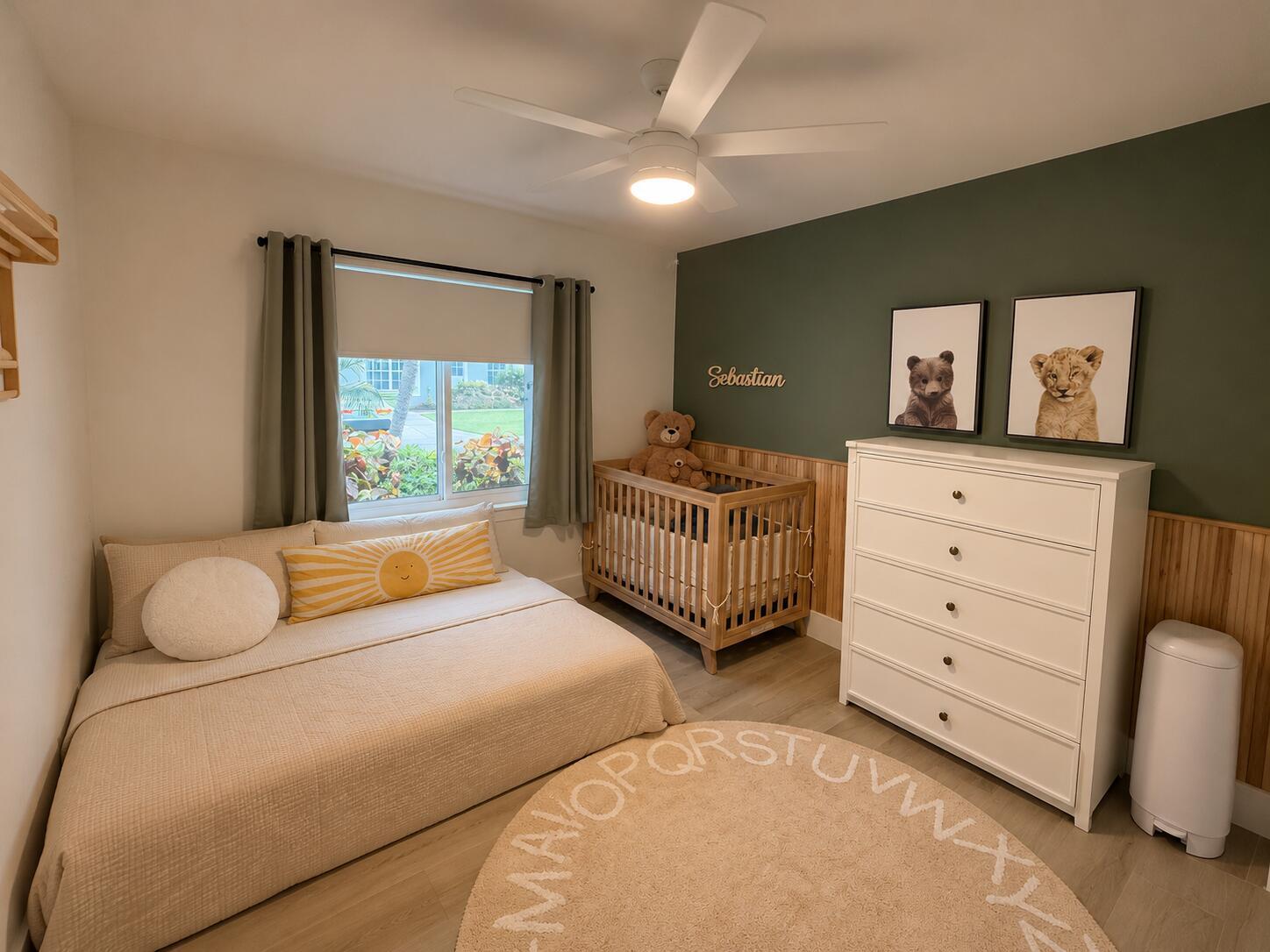A nursery features a bed, a wooden crib, a white dresser, and an olive green wall — 1073 Aspri Way, Riviera Beach FL 33418, RIVIERA BEACH, FL