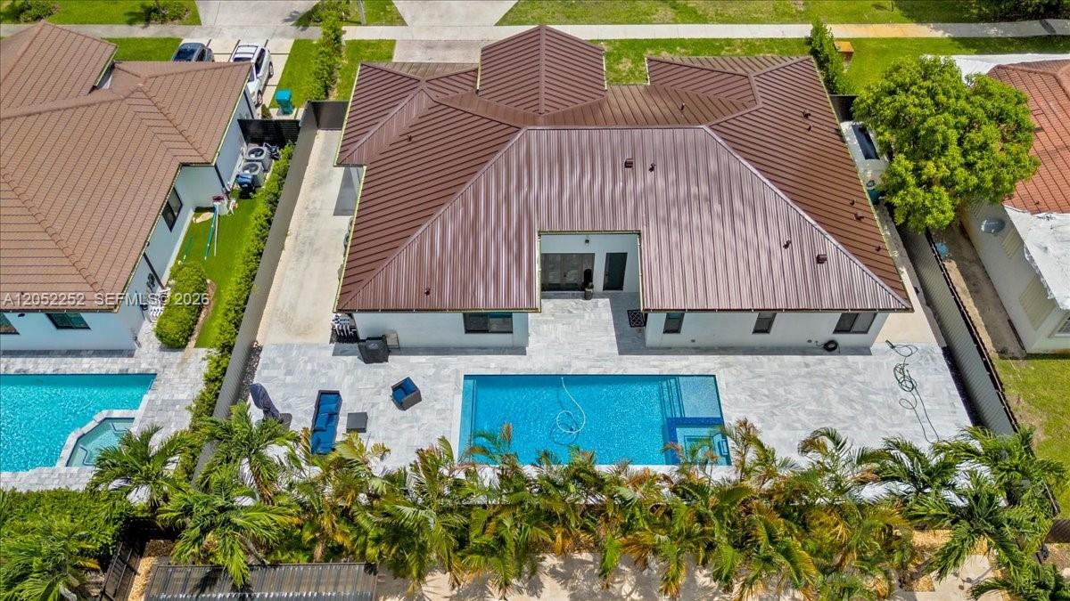 An aerial view shows a house with a brown metal roof and a backyard pool — 16234 SW 48th Ter, Miami FL 33185, MIAMI, FL