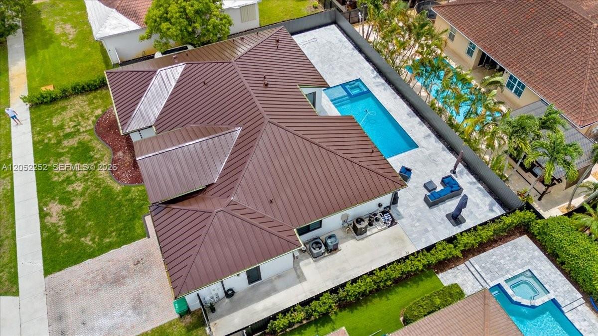 An aerial view shows a house with a brown metal roof, a pool, and patio — 16234 SW 48th Ter, Miami FL 33185, MIAMI, FL