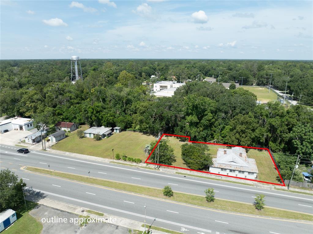 An aerial view shows a rectangular lot with a house outlined in red along a road — 14962 NE US HIGHWAY 301, WALDO, FL