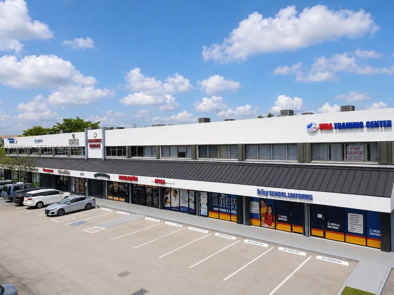 An exterior view of a commercial strip mall with a parking lot in the foreground — 4355 W 16th Ave, Hialeah FL 33012, HIALEAH, FL