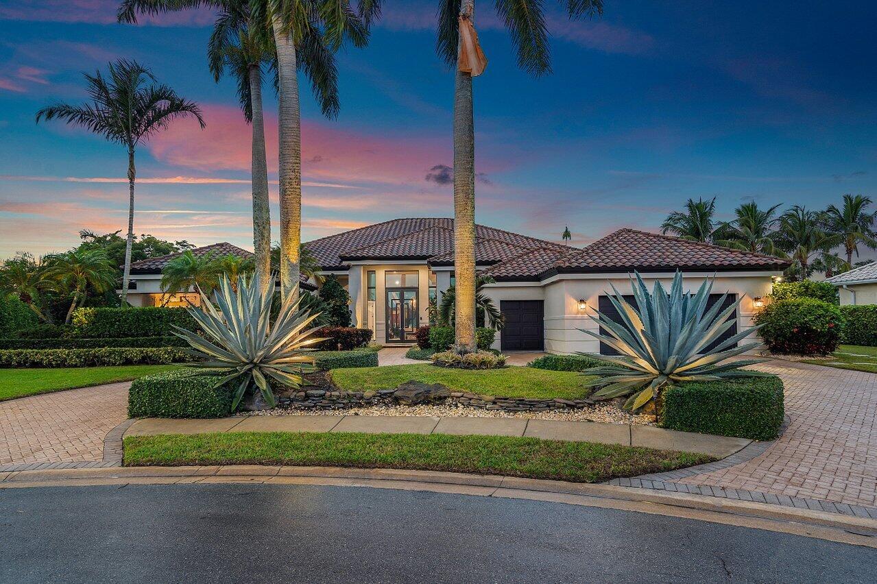 A single-story house with a tiled roof, palm trees, and agave plants at dusk — 4848 Chamal Circle, Boca Raton FL 33487, BOCA RATON, FL
