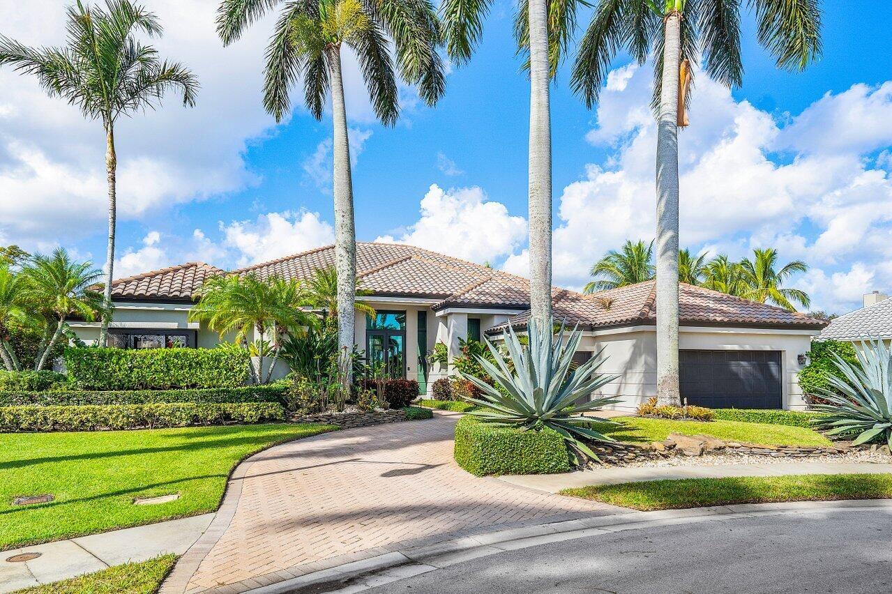 A single-story house with a tiled roof, palm trees, and a paved driveway — 4848 Chamal Circle, Boca Raton FL 33487, BOCA RATON, FL