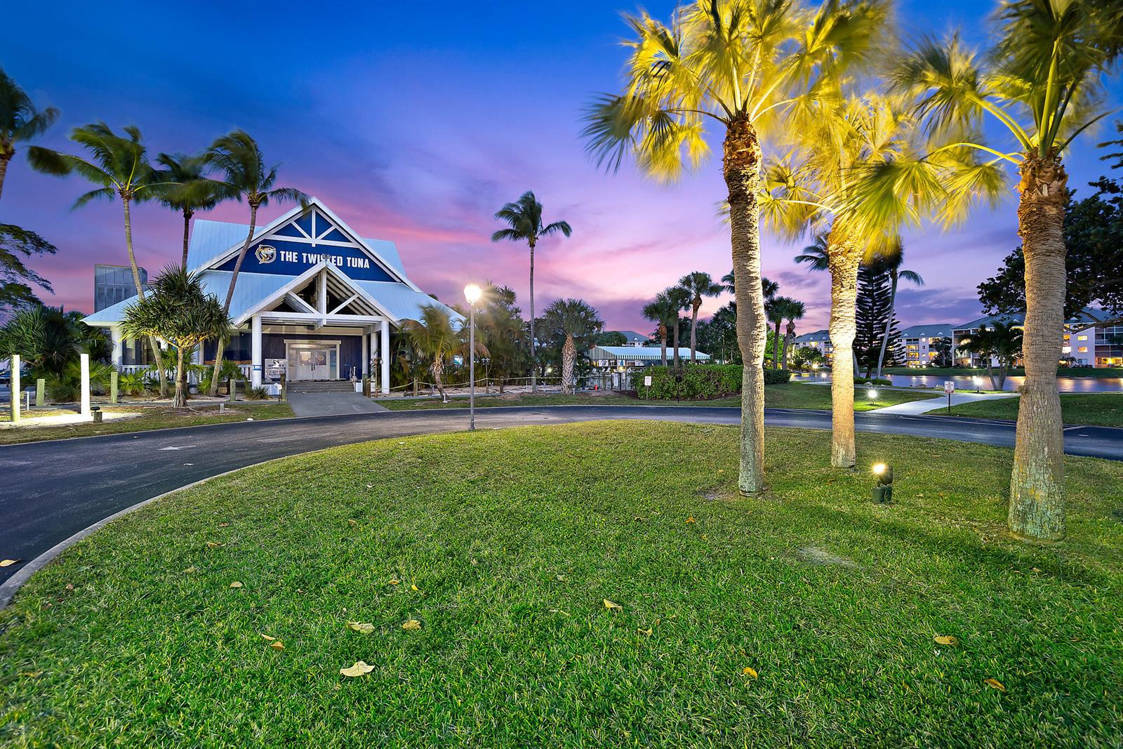The exterior of The Twisted Tuna restaurant features a blue and white building with palm trees — 353 S US Hwy 1 # f208, Jupiter FL 33477, JUPITER, FL