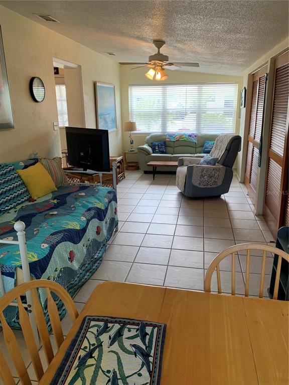 A living room features a daybed, a sofa, a recliner, and a dining table — 1935 S CENTRAL AVENUE, FLAGLER BEACH, FL