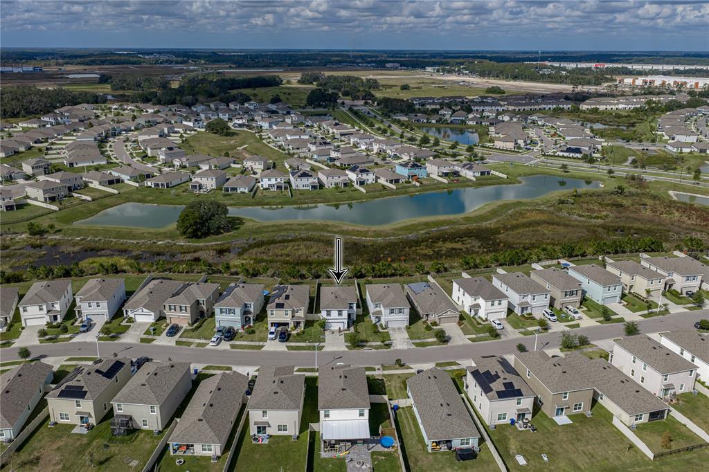 An aerial view shows a suburban neighborhood with houses, a pond, and a marked residence — 10951 PENNY GALE LOOP, SAN ANTONIO, FL