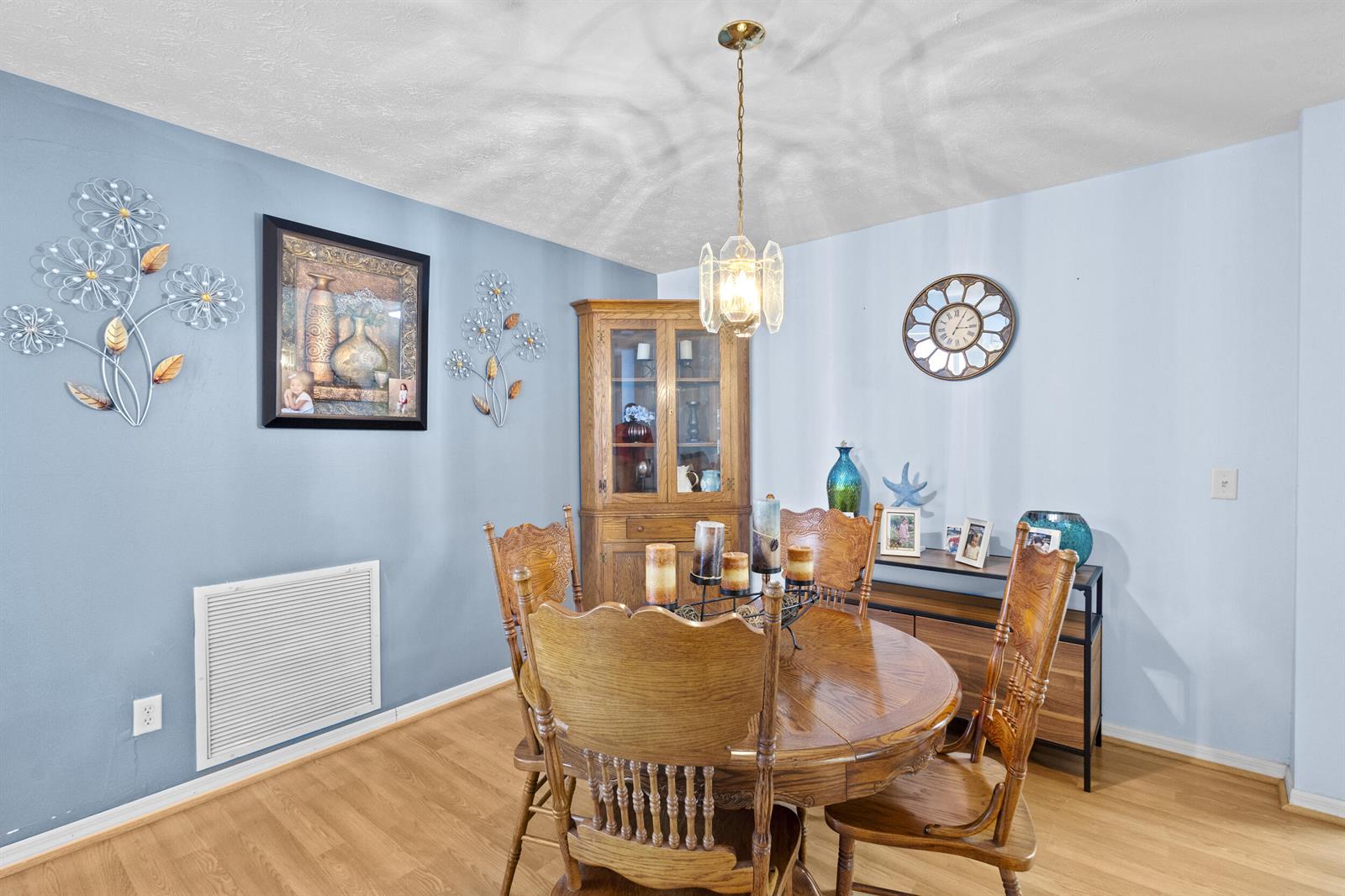 A dining room features a wooden table and chairs, a hutch, and blue walls — 6527 Alheli, Fort Pierce FL 34951, FORT PIERCE, FL