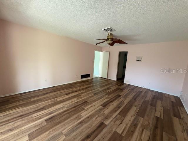An empty room with light pink walls, wood-look flooring, and a ceiling fan — 4240 CHARING CROSS ROAD, SARASOTA, FL