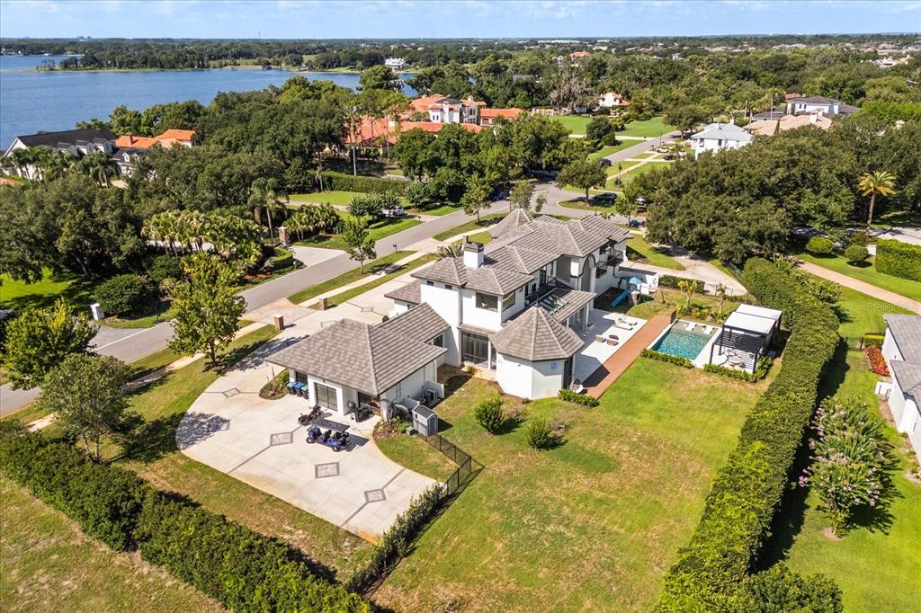 An aerial view shows a large multi-story house with a pool, patio, and driveway — 12237 PARK AVENUE, WINDERMERE, FL
