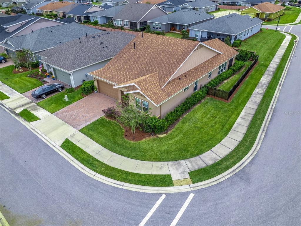 An aerial view shows a tan house with a brown roof on a corner lot — 5672 NW 40TH PLACE, OCALA, FL