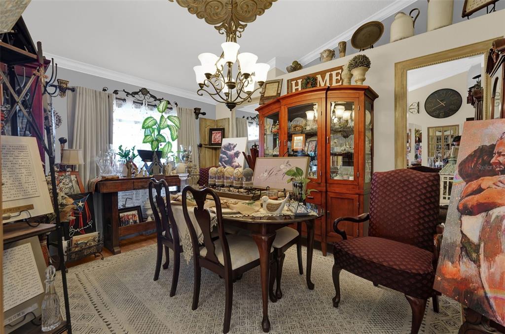 A dining room features a wooden table, chairs, a china cabinet, and a chandelier — 3279 COUNTRYSIDE VIEW DRIVE, ST CLOUD, FL