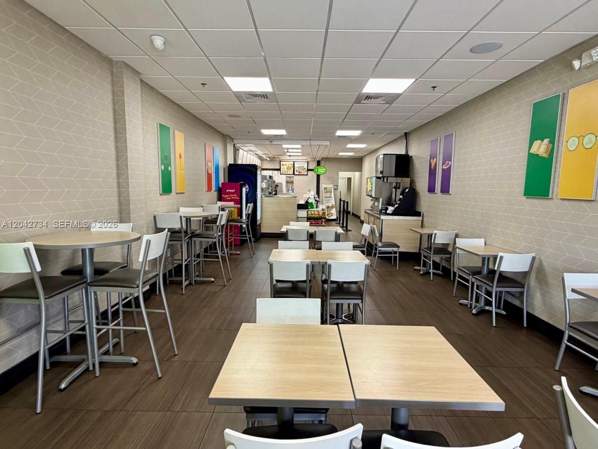 The interior of a commercial restaurant space features tables, chairs, and tiled walls — 7500 NW 25th St # 107, Miami FL 33122, MIAMI, FL