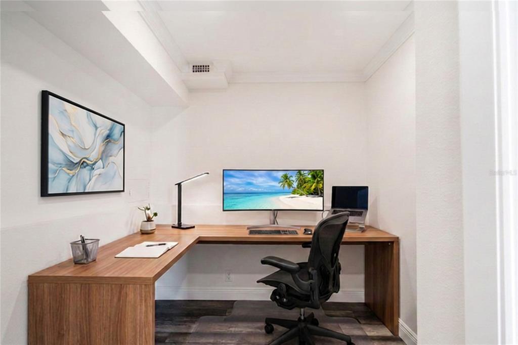 A spacious lobby with tile flooring, a drop ceiling, and decorative artwork on yellow walls — 31 ISLAND WAY UNIT 703, CLEARWATER BEACH, FL