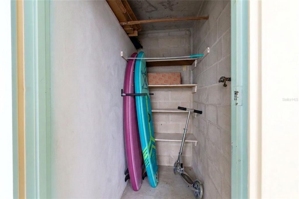 An aerial view of a multi-story white apartment building with a pool and boat docks — 31 ISLAND WAY UNIT 703, CLEARWATER BEACH, FL