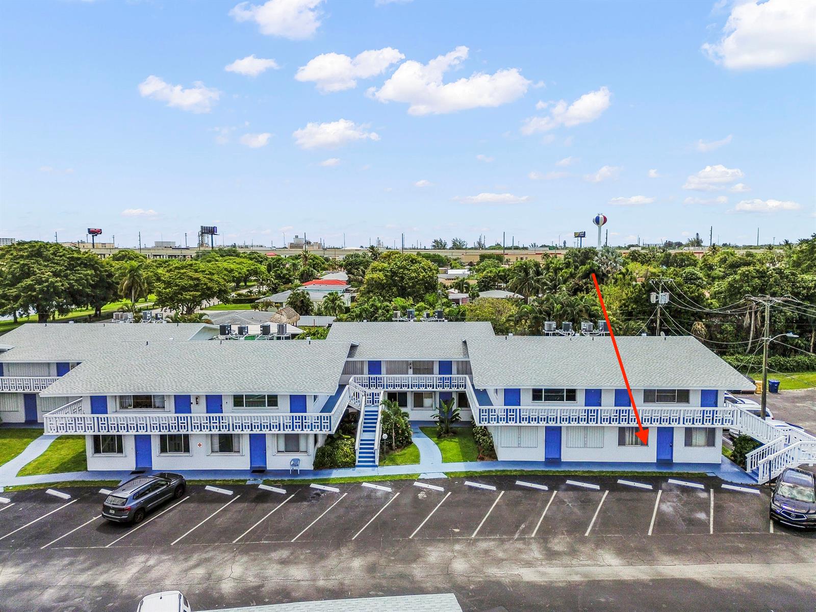 An aerial view shows a two-story motel building with a red arrow pointing to a unit — 1950 Lake Osborne Drive # 9, FL 33461, FL