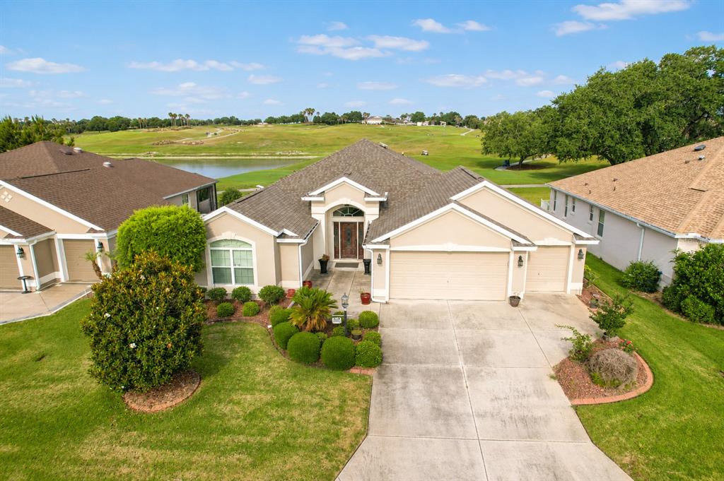 An aerial view of a single-story suburban house with a garage and golf course view — 2696 MIDLAND TERRACE, THE VILLAGES, FL