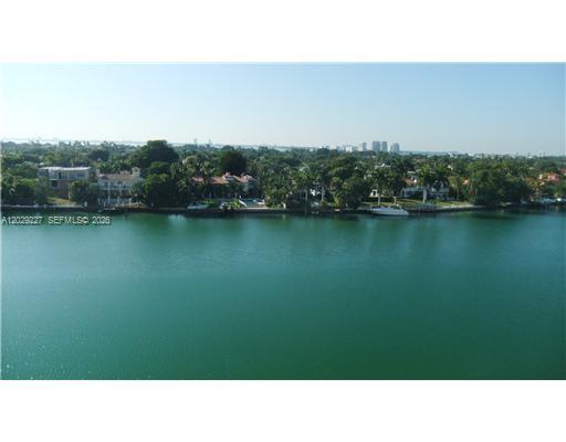 A high-angle view shows numerous yachts navigating a waterway lined with trees and buildings — 5700 Collins Ave # 8K, Miami Beach FL 33140, MIAMI BEACH, FL