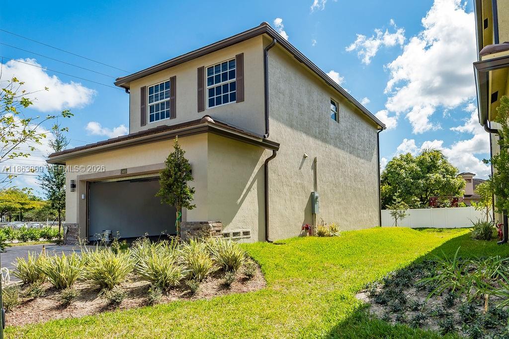 A two-story house with a beige stucco exterior and an attached garage — 5400 NW 57th Ct, Tamarac FL 33319, TAMARAC, FL