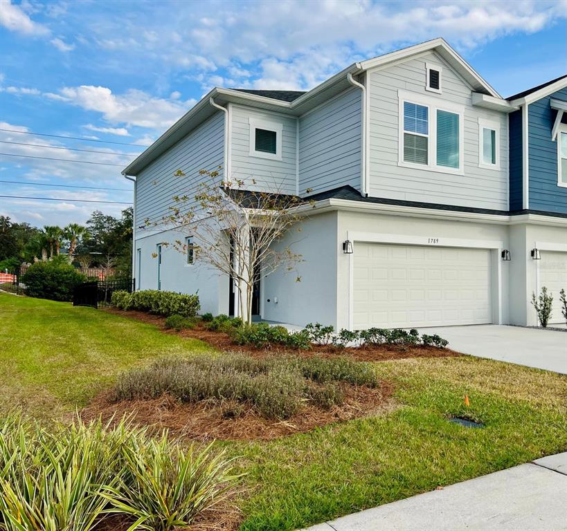 A two-story light blue house with a two-car garage and a landscaped front yard — 1789 TERRAPIN ROAD, OCOEE, FL