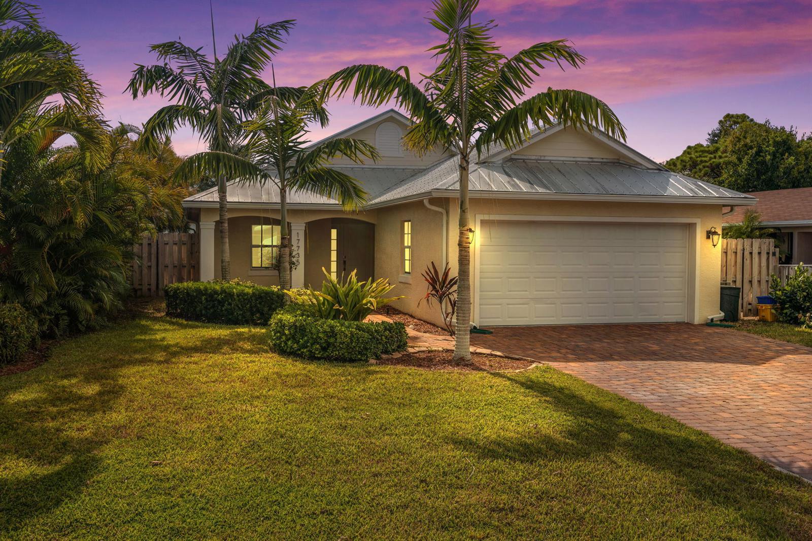 A single-story house with a metal roof, two palm trees, and a brick paver driveway — 17735 CARVER Avenue, Jupiter FL 33458, JUPITER, FL