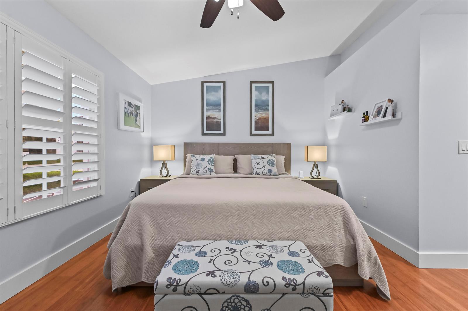 A bedroom features a bed with a patterned bench, two lamps, and wall art — 866 E Jeffery Street, Boca Raton FL 33487, BOCA RATON, FL