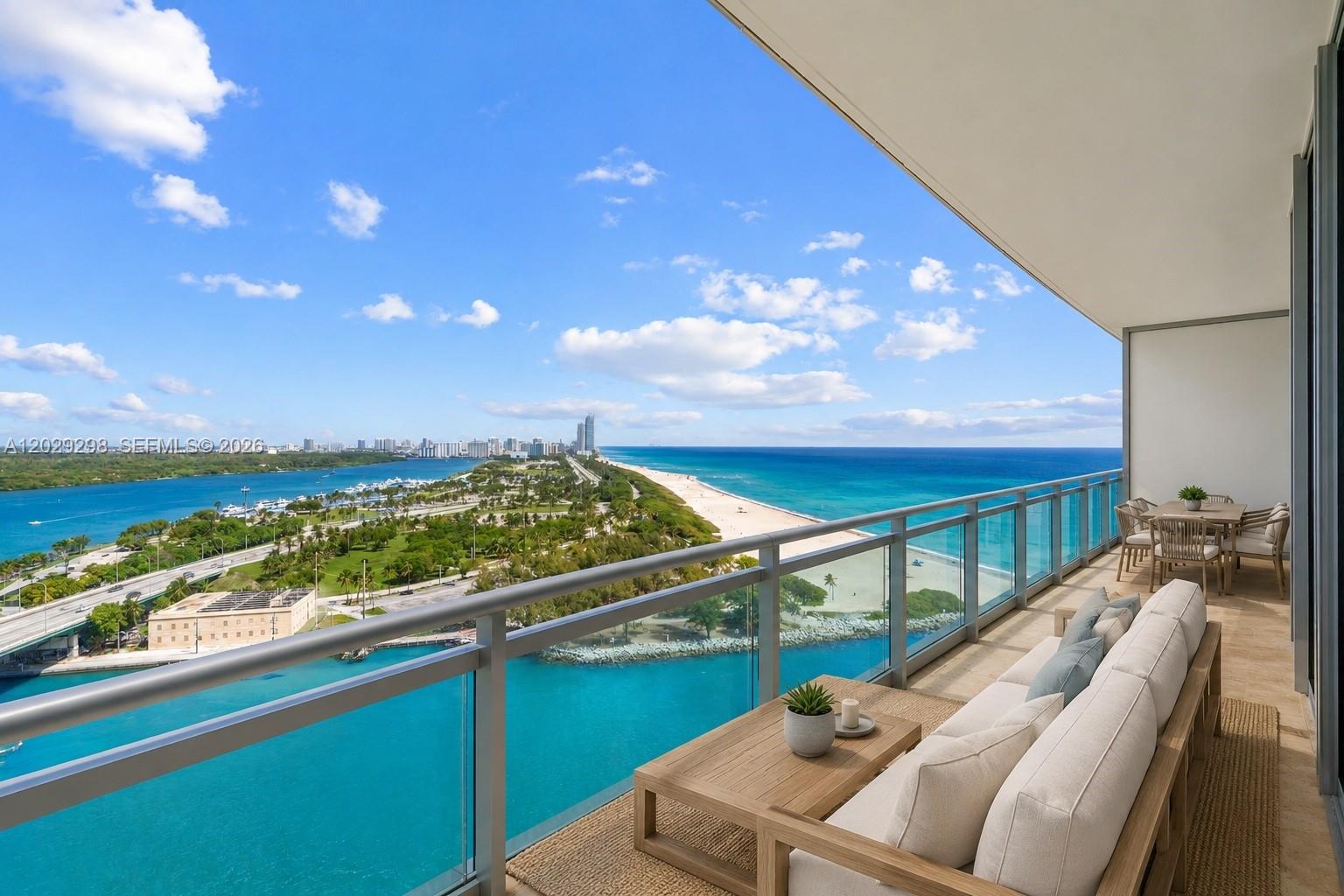 A balcony with outdoor seating overlooks a coastal landscape with a beach and ocean — 10295 Collins Ave # 1606, Bal Harbour FL 33154, BAL HARBOUR, FL